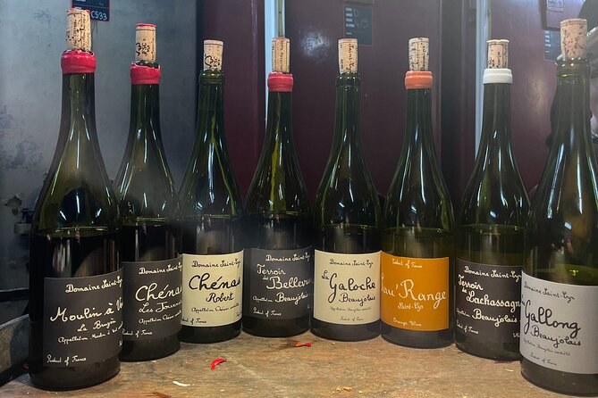 A line of bottles labelled with the crus, Moulin-à-Vent and Chénas among them