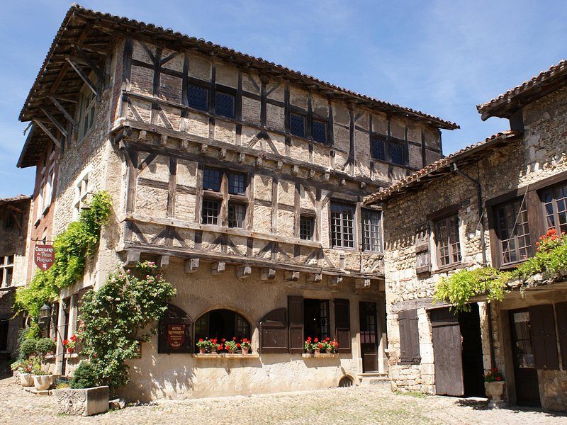 Half-timbered medieval houses with flower boxes around a cobbled square